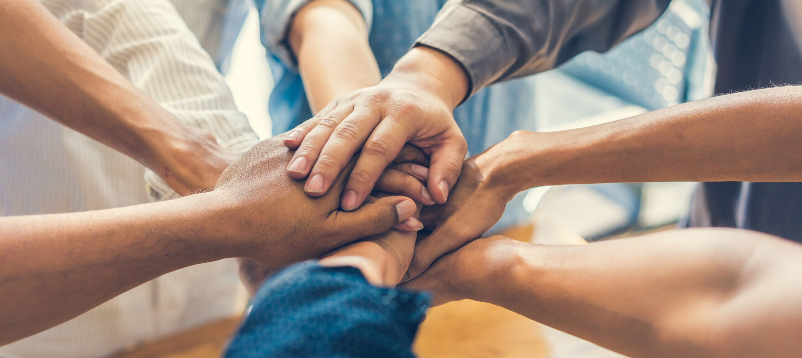 business people making pile of hands , soft focus, vintage tone